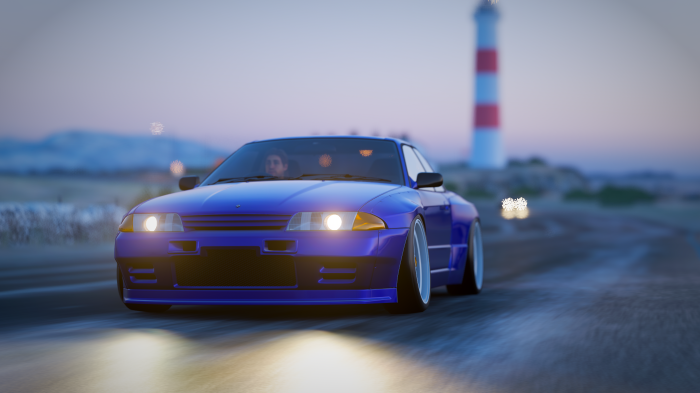 Nissan Skyline GT-R R32 driving near a lighthouse