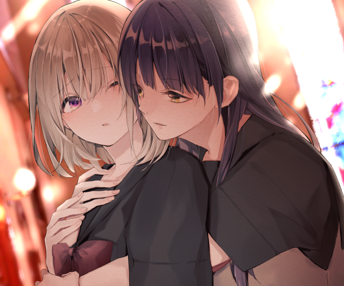 Two girls embracing, one with blonde hair, the other with dark hair