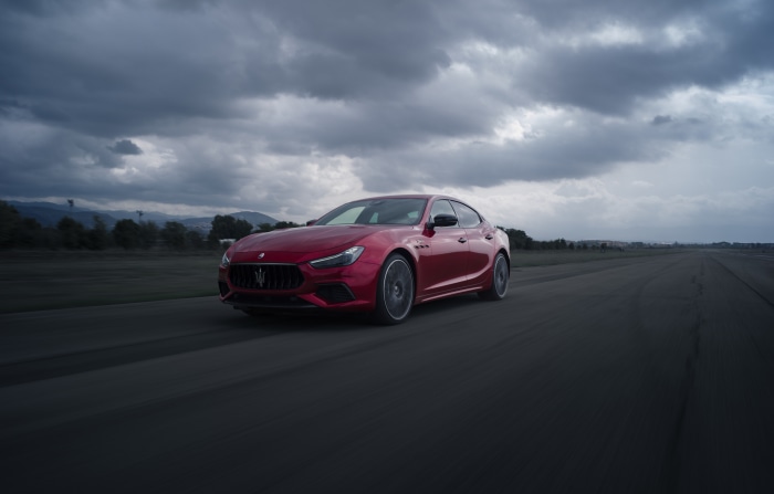 Red Maserati Ghibli Trofeo on a Racetrack