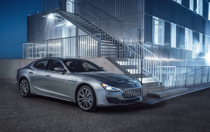 Silver Maserati Ghibli GT Hybrid parked outside modern building