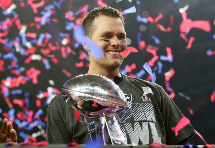 Tom Brady holding the Super Bowl trophy