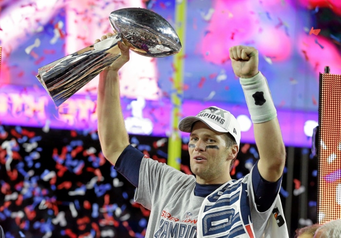Tom Brady holding the Super Bowl trophy