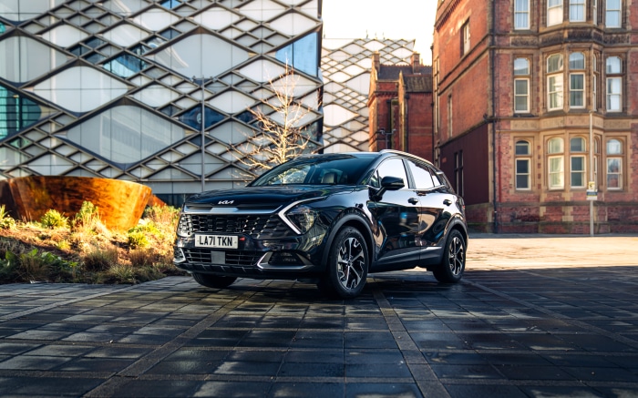 Black Kia Sportage SUV parked in urban setting