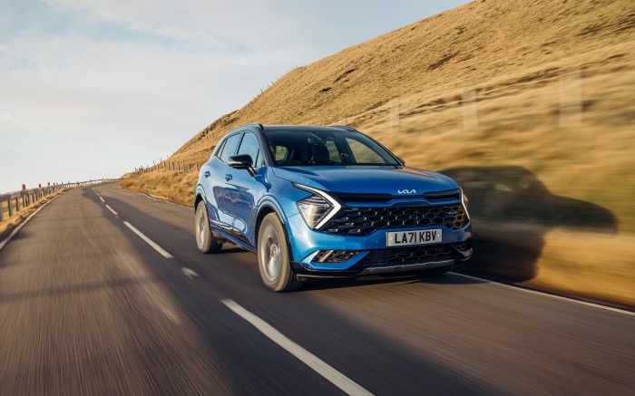 Blue Kia Sportage HEV GT-Line S driving on a road