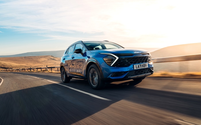 Blue Kia Sportage HEV GT-Line S driving on a road
