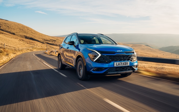 Blue Kia Sportage HEV GT-Line S driving on a road
