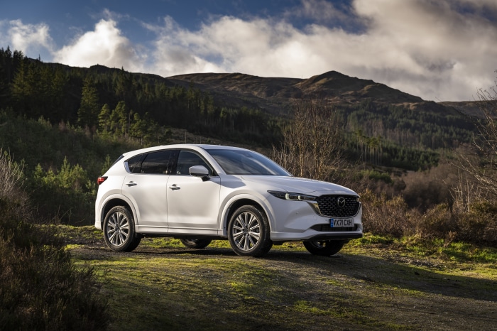 White Mazda CX-5 SUV parked on a dirt road