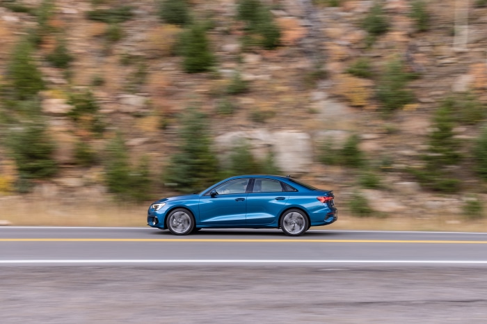 Blue Audi A3 Sedan 40 TFSI quattro driving on a road