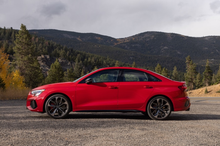 Red Audi A3 Sedan parked on gravel road
