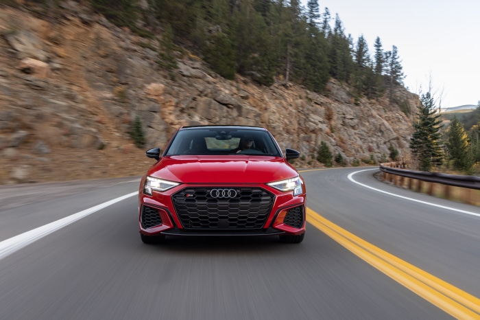 Red Audi S3 Sedan driving on a mountain road