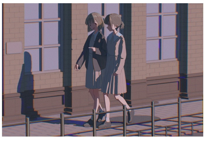 Two girls walking in front of a brick building