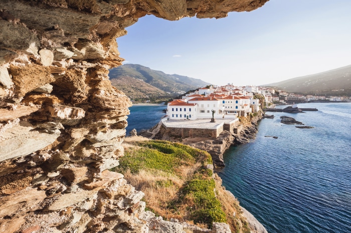 White buildings on a cliff overlooking the sea in Greece