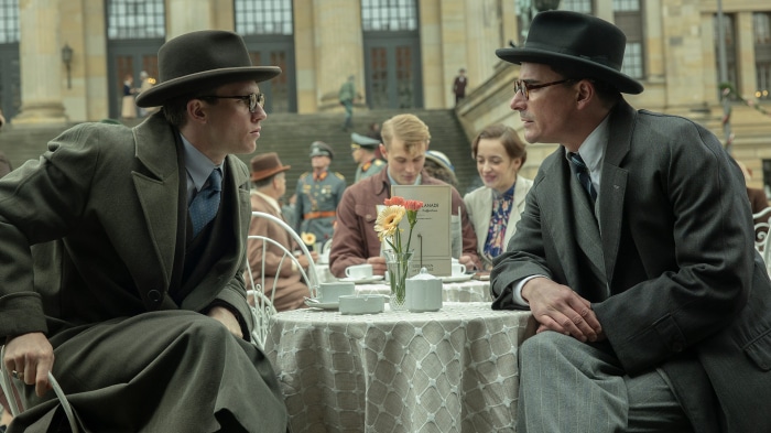 Two men in hats and suits at a cafe in Munich