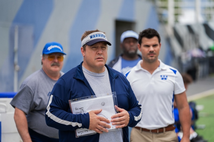 Kevin James and Taylor Lautner on a football field