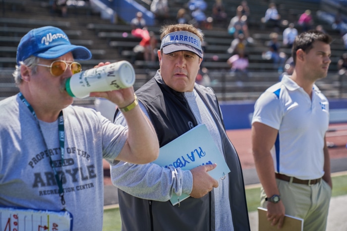 Kevin James and Taylor Lautner on a football field