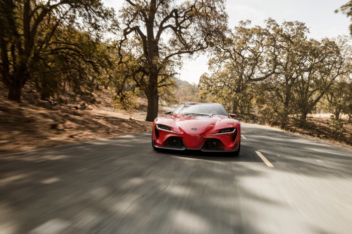 Red Toyota FT-1 Supercar driving on a road