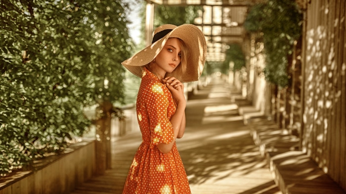 Woman in a wide-brimmed hat and polka dot dress