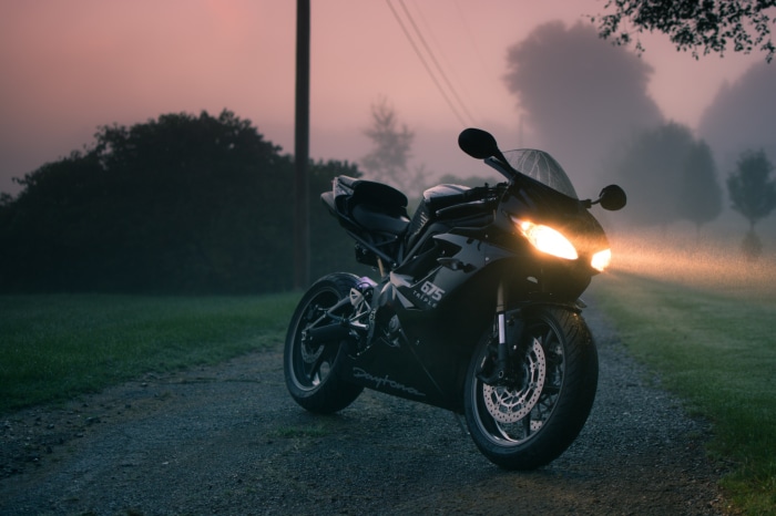 Triumph Daytona 675 motorcycle on a foggy road