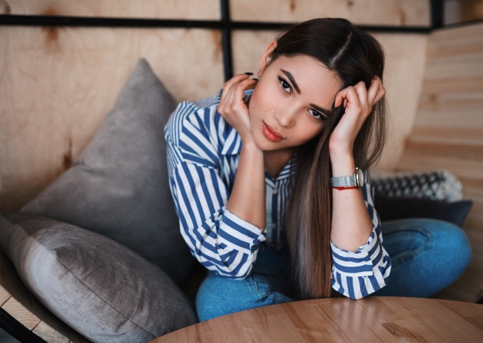 Brunette woman sitting on a couch