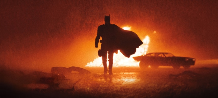Batman in front of an explosion