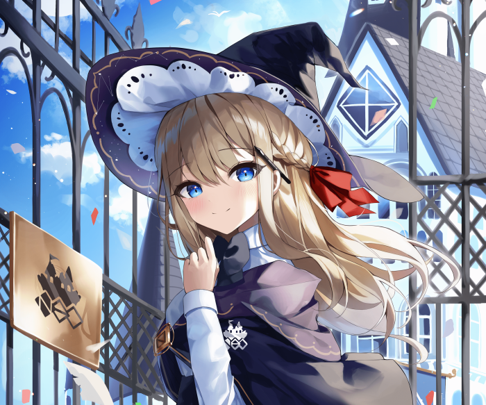 Girl in witch hat near a building