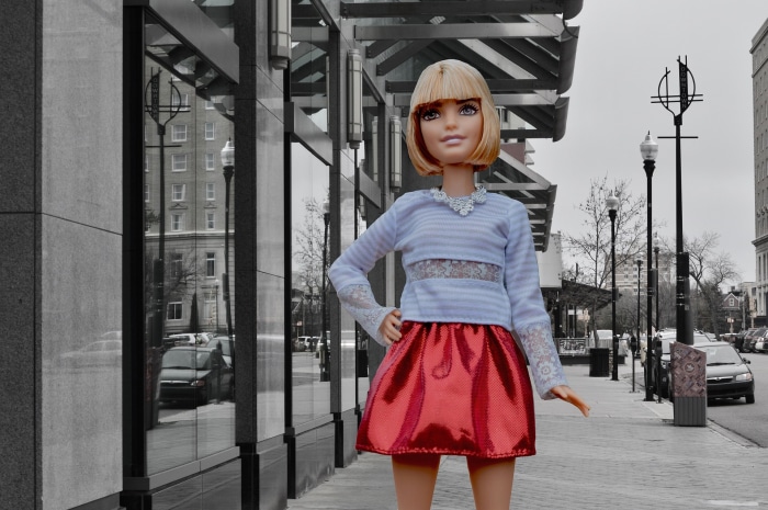 Barbie doll in a red skirt and blue top