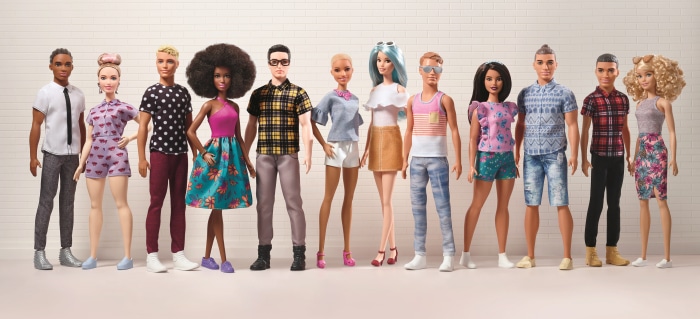 Group of diverse Barbie dolls standing together