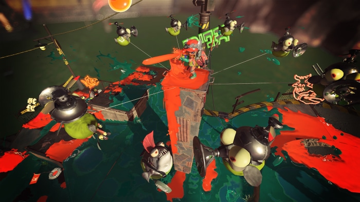 Splatoon 3 characters in a battle with orange and green ink
