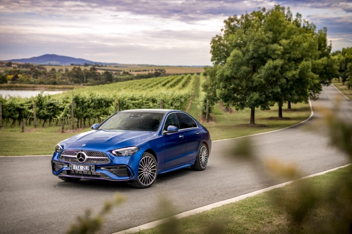 Blue Mercedes-Benz C 300 AMG Line sedan in vineyard landscape