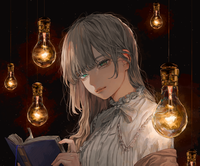 Girl reading a book under hanging light bulbs