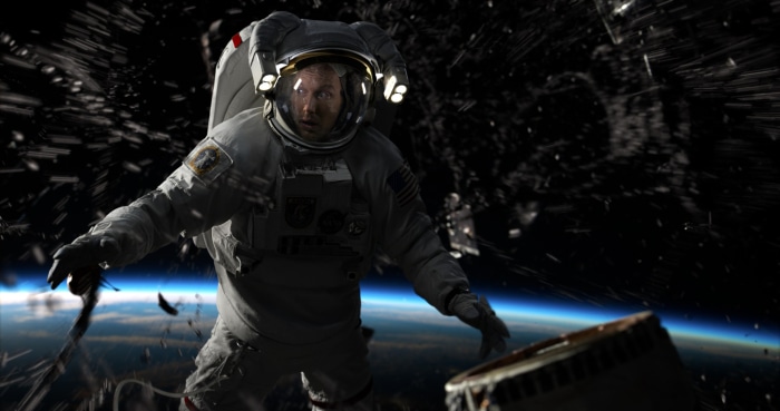 Astronaut in space debris field