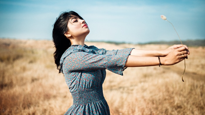 Woman in a field holding a plant