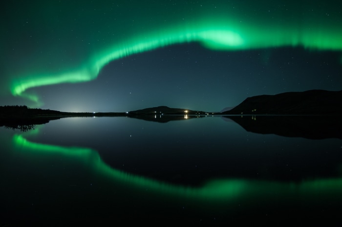 Aurora Borealis reflected in a lake at night