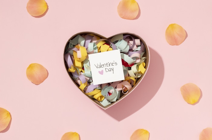 Heart-shaped box with confetti and Valentine's Day card