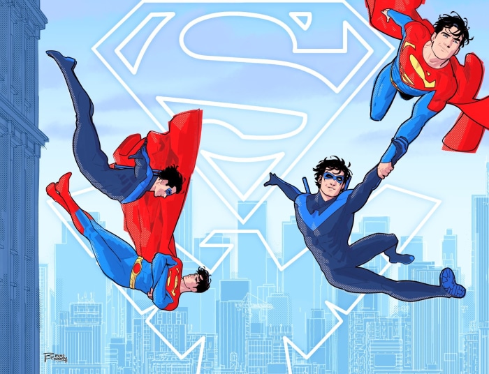 Superman and Nightwing flying over city