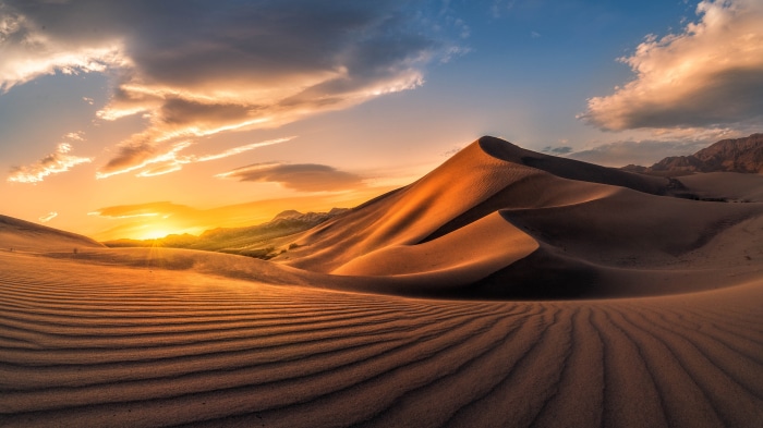 Desert Dunes at Sunrise with Dramatic Clouds
