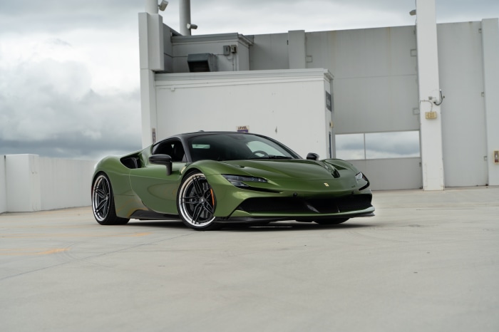 Green Ferrari SF90 Stradale parked on rooftop