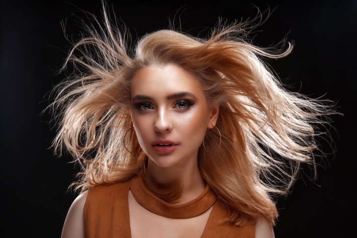 Woman with blonde hair blowing in the wind