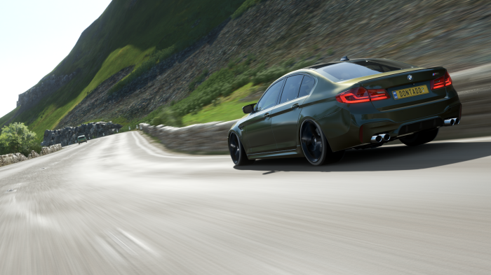BMW M5 driving on a winding road