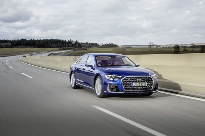 Blue Audi S8 driving on a highway