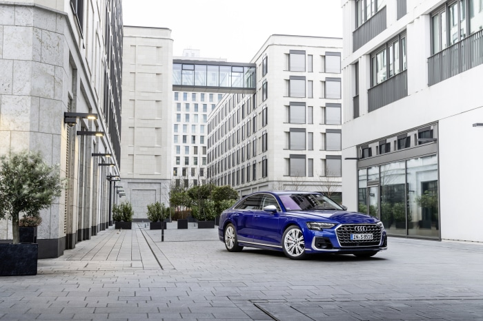 Blue Audi S8 parked in a modern city courtyard
