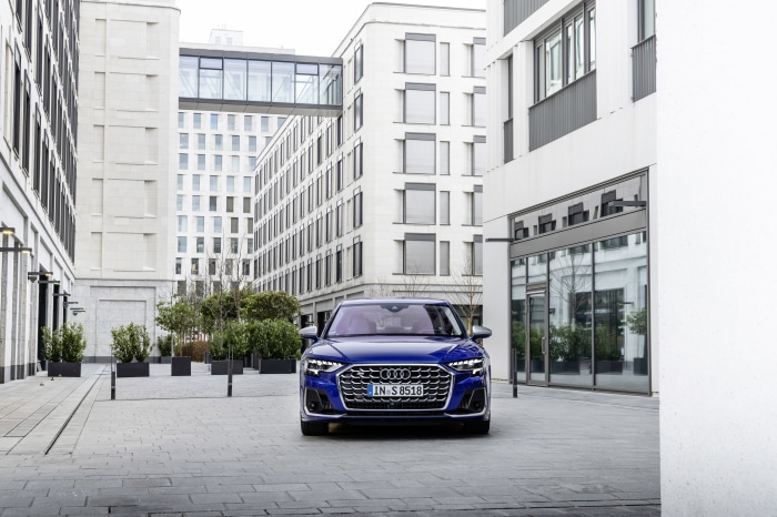 Blue Audi S8 parked in a modern city courtyard