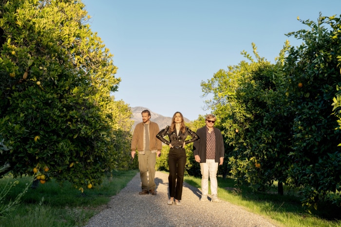Lily Collins, Jason Segel, and Jesse Plemons in an orchard