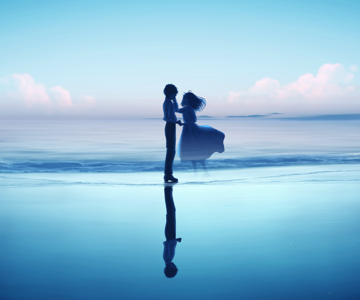 Couple reflected on a beach at sunset
