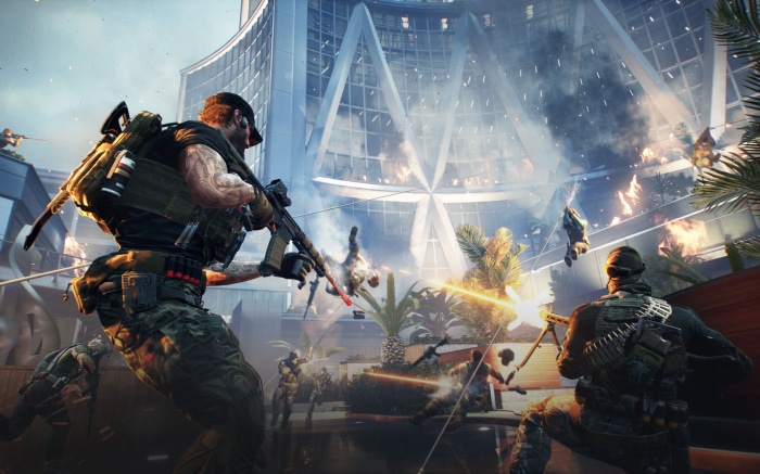 Soldiers in a firefight in front of a modern building