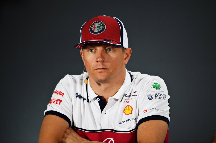 Kimi Räikkönen wearing Alfa Romeo cap and shirt