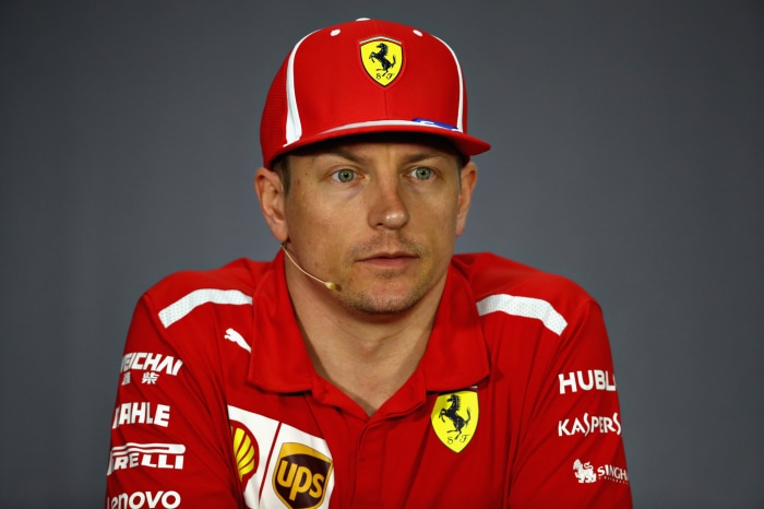 Kimi Räikkönen in a Ferrari racing suit and cap