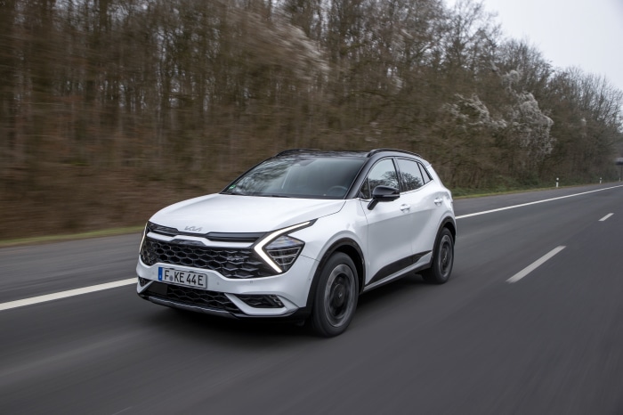 White Kia Sportage GT-Line PHEV driving on a road