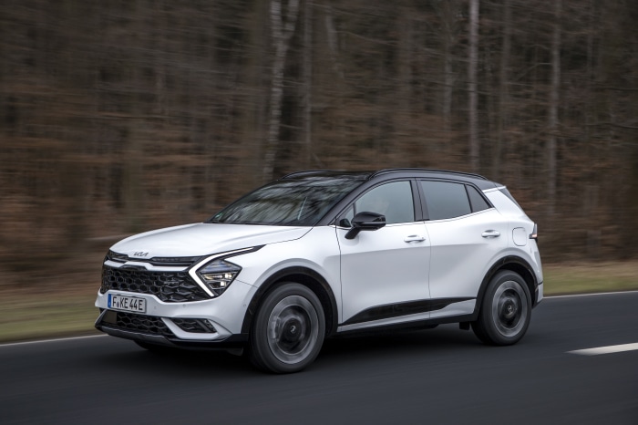 White Kia Sportage GT-Line PHEV driving on a road