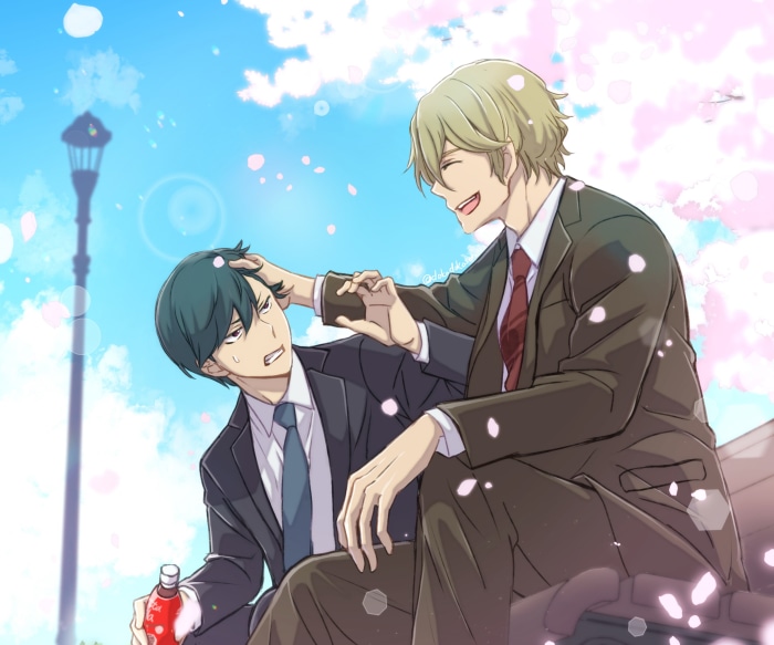 Two men in suits sitting outdoors